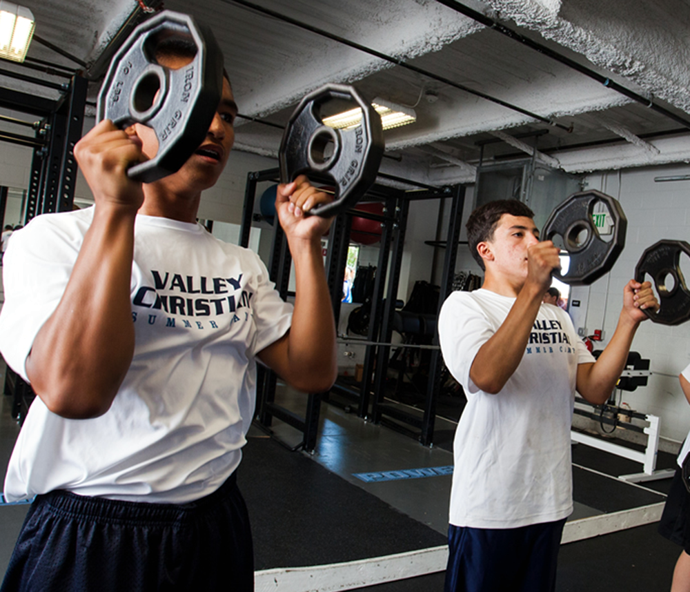 students lift weights